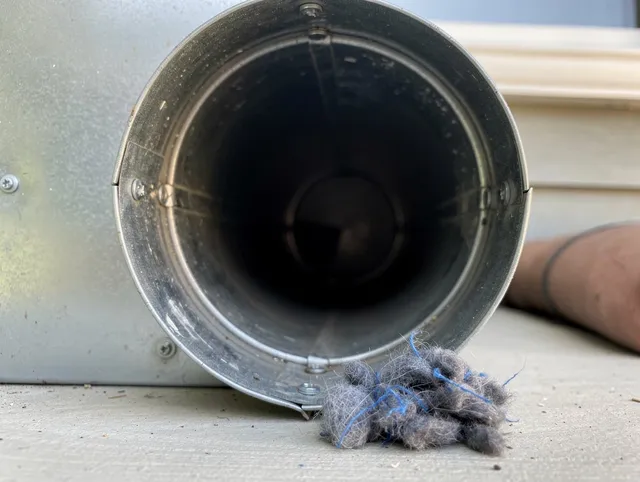 Darien Dryer Vent Cleaning technician using specialized equipment to clear severe dryer vent blockage in Darien